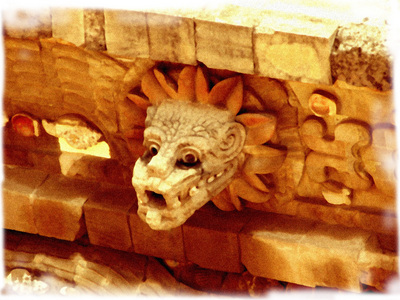Statue of Quetzalcoatl's head above entrance to temple in La Venta